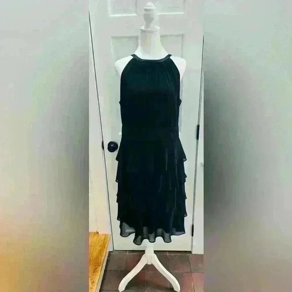 Evan Picone black sleeveless dress, pleated neckline, tier bottom, satin waist. - Picture 1 of 9
